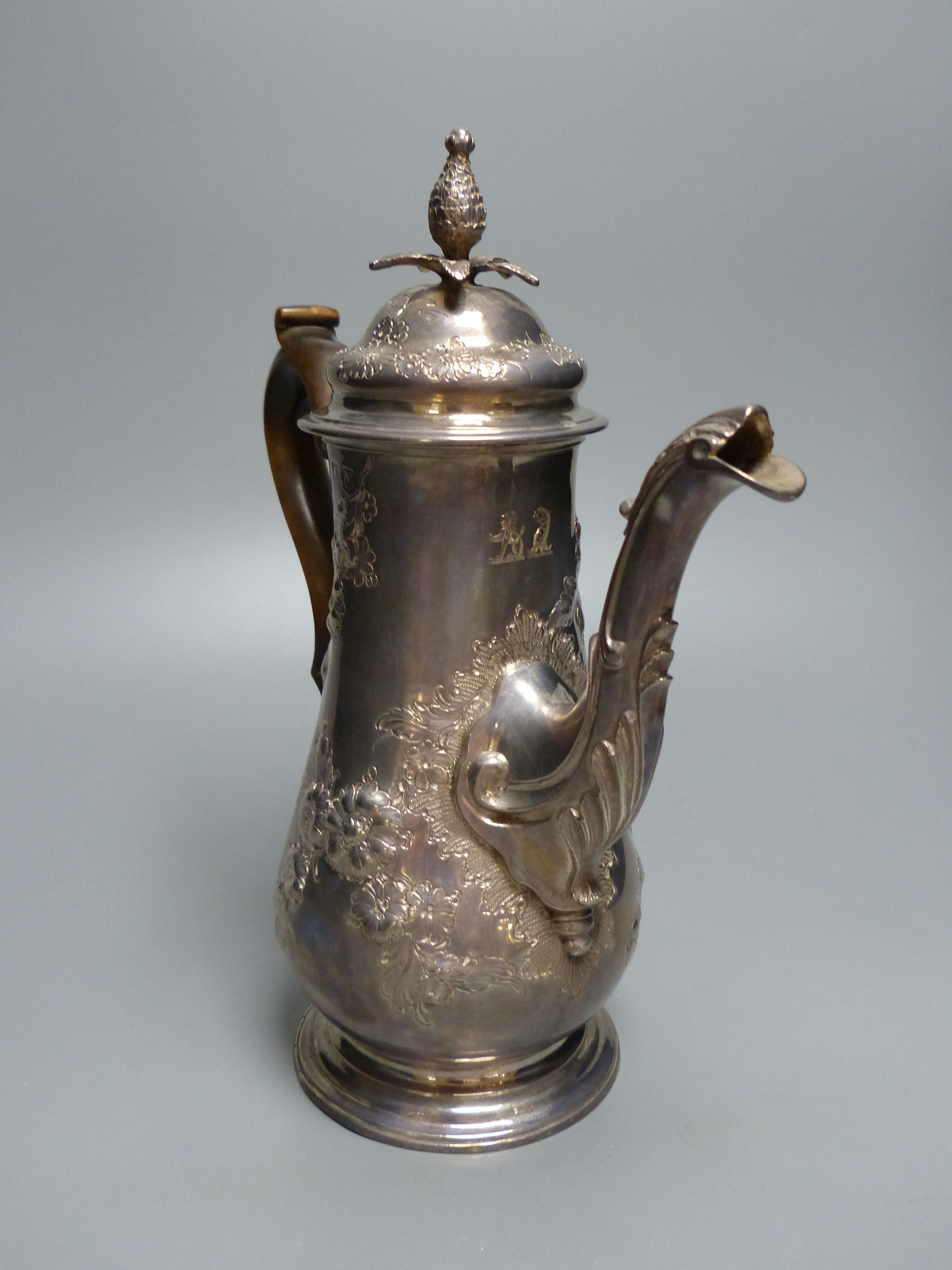 An early George III silver coffee pot, with later embossed decoration, maker ?D over WI,
